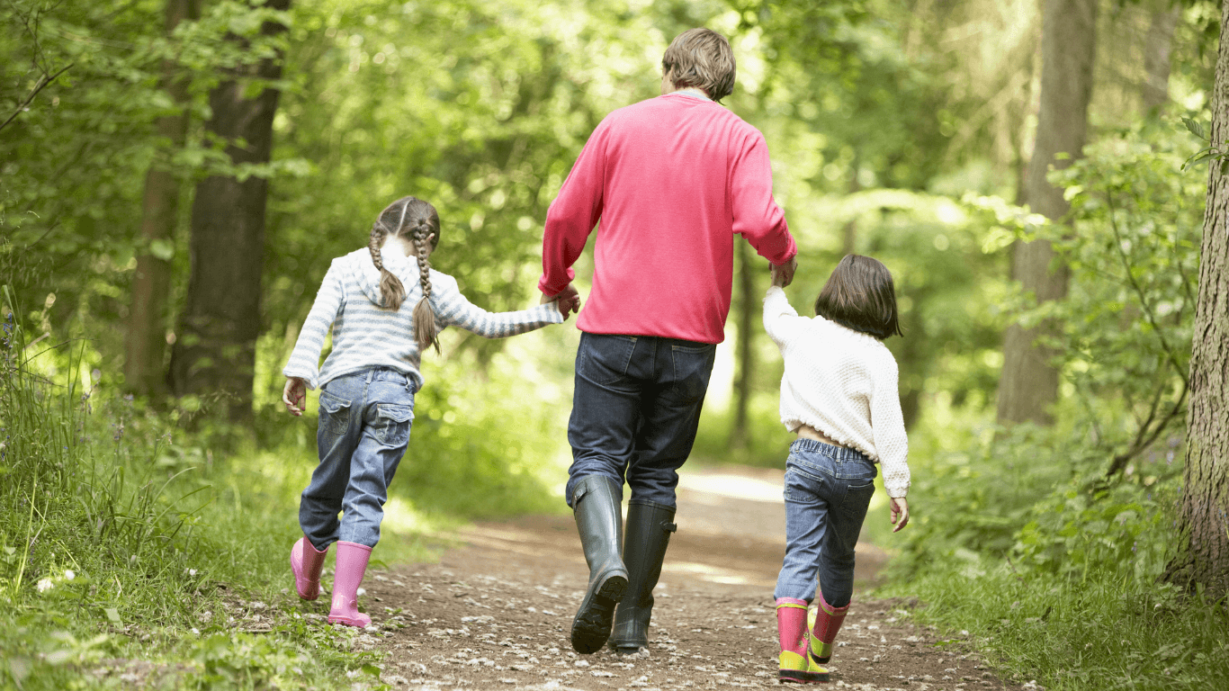 Fostering family walking through forest