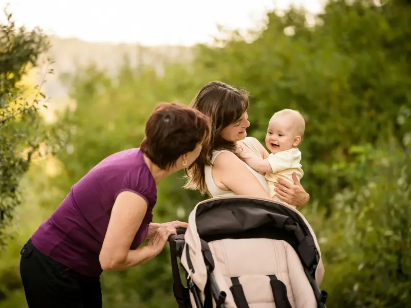Foster carer providing support and guidance to a parent in a nurturing way.