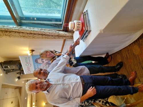 Carers Michelle and Andrew Scott cut the cake with Recruitment Manager, Barrie Lewis